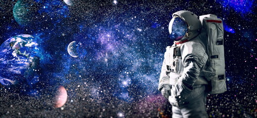 Astronaut in space in the solar system Earth. Blue light on background. Elements of this image...