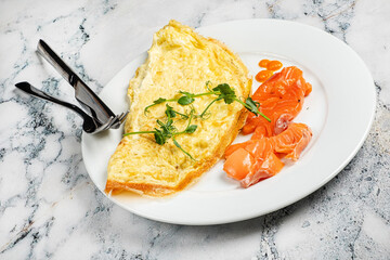 omelet with salmon on the white plate