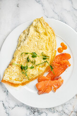 omelet with salmon on the white plate