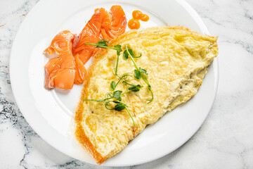 omelet with salmon on the white plate