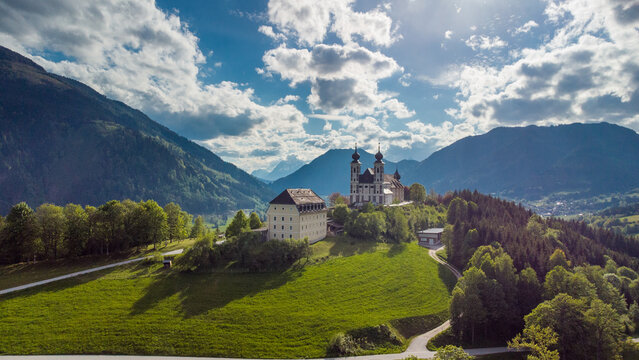 Wallfahrtskirche frauenberg is a beautiful church in the middle of Austria, drone panorama view of a church next to enn river in central Austria on a sunny summer day.
