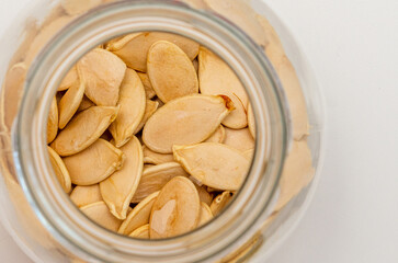 pumpkin seeds in a glass jar, top view
