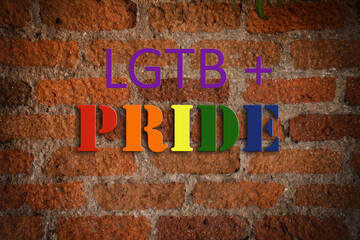 lgtb community pride text on aged brick wall