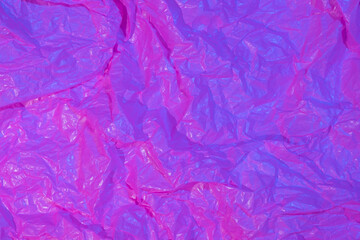 Abstract crumpled paper background in neon light