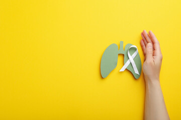 Lung Cancer Awareness Month concept on yellow background