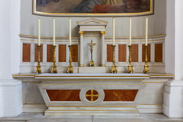 Altar table with six candles and Jesus on the Cross. Inside the catholic church of the Jesuits...