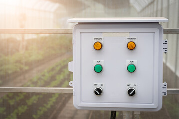 Control box automatic watering timer in organic farm inside greenhouse.
