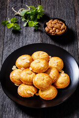 almond cookies on black plate, top view