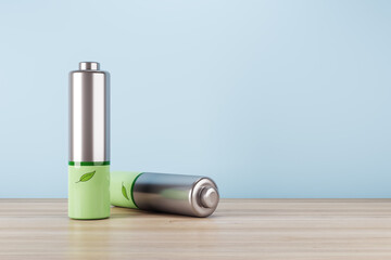 Green technology, nature resources and green energy concept with green leaf printed on silver batteries on wooden table and blank blue wall with space for your logo background. 3D rendering, mockup