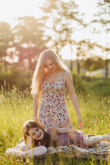 Mother and little daughter playing together in a park