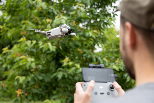 DJI Mini 3 Pro drone in flight and controller in the foreground, June 09, 2022, Germany	