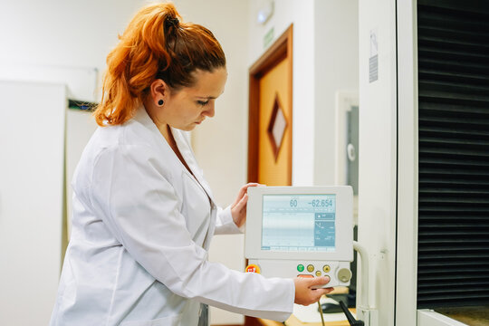 Concentrated scientist setting up equipment in modern laboratory