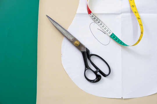 Measuring tape and scissors on table