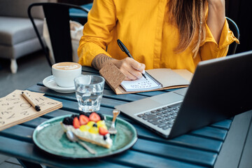 Woman numerologist working with numbers in notepad and laptop. Numerology Numbers