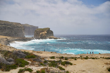 Fototapeta na wymiar Wild coast at Gozo island, Malta on a windy day in June 2022. 