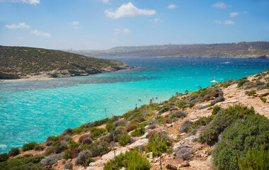 Blue lagoon beach in Malta on a windy day in June 2022.