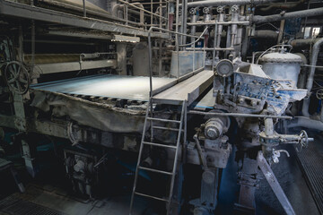 Paper production machine in wastepaper recycling factory. Paper and pulp mill.