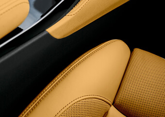 Modern luxury car brown leather interior. Part of perforated leather car seat details. Brown...