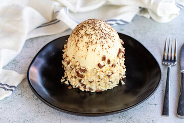White chocolate cake. Cake with profiteroles on a stone background. Celebration cake. close up