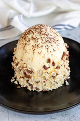 White chocolate cake. Cake with profiteroles on a stone background. Celebration cake. close up