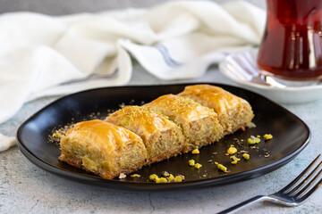 Pistachio baklava. Traditional Mediterranean cuisine delicacies. Baklava on stone background. Close-up. local name fistikli sarma baklava