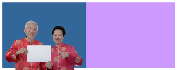 Asian senior couple Chinese new year costume holding blank sign for advertising
