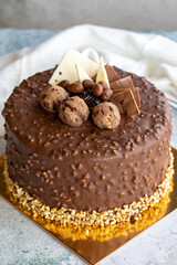 Cake with chocolate chips and profiteroles. Birthday or celebration cake. close up