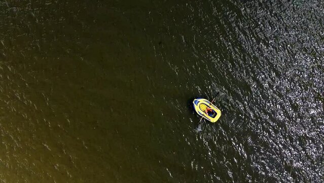 Drone shot of small boat dingy in rippling sea water.
