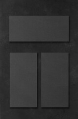 Black rectangular mockups on a dark concrete background. Design elements or portfolio. Copy space