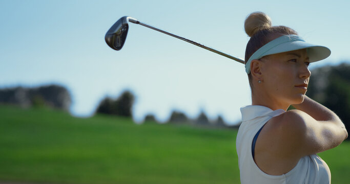 Confident Woman Playing Golf On Fairway. Golfer Swinging Ball At Country Club.