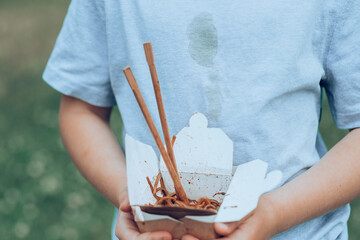 Dirty soy sauce stains on t-shirt. Takeaway food. outdoors