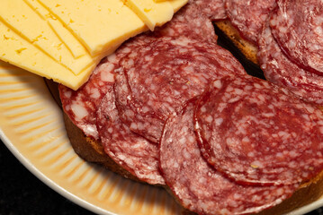A set of sliced products for a quick snack on a plate