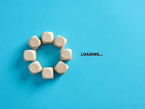 Wooden cubes with the word loading in loading progress indicator bar.