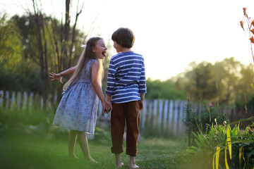 Fototapeta premium Children walk in the summer in nature. Child on a sunny spring morning in the park. Traveling with children.