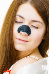 Woman with nose mask pore strips