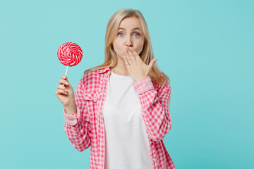 Young happy shocked caucasian woman she 30s wears pink shirt white t-shirt hold in hand lollipop...