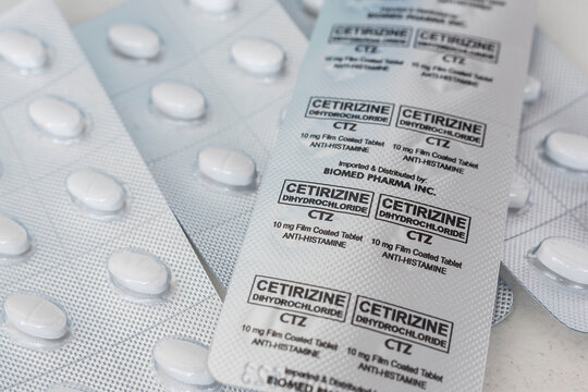 Philippines - May 2022: Blister packs of Cetrizine tablets. Antihistamine medication for sale at a drugstore or pharmacy.