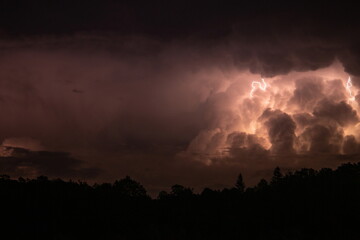 Lightning in the sky during a storm at night
