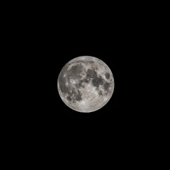 Detailed image of the full moon isolated on black.