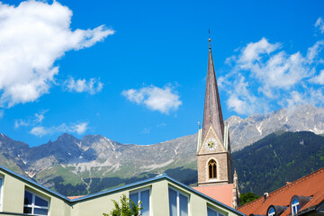 Fototapeta na wymiar Gothic cathedral tower in Innsbruck Old town in Alps mountains, Tyrol, Austria