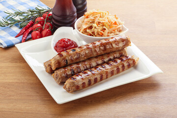 Grilled sausages with cabbage and sauce