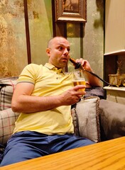 man drinking beer and using phone