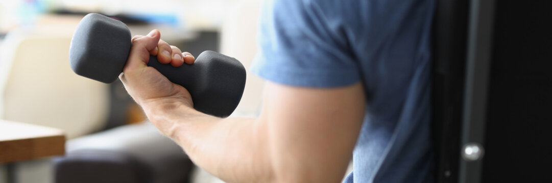 Strong man lifting dumbbell to achieve personal sport goal