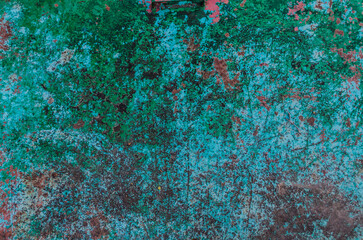 Aged green background with peeling paint. Grunge background. Old scratched painted surface.