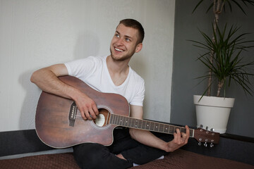 Obraz premium A man plays guitar and laughs