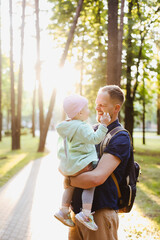 father's day concept. Dad and baby girl playing together outdoors in summer 