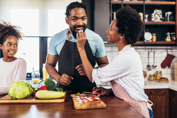 Happy multigenerational african american family make dinner together.