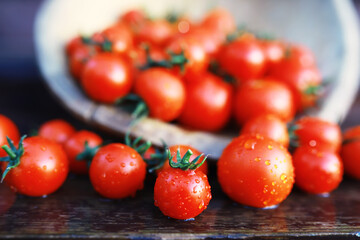 Ecological fresh farm cherry tomatoes on a wooden background.