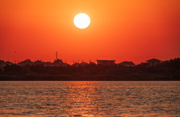 The sun goes down over a lake