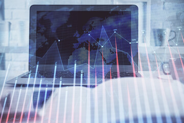 Stock market graph and table with computer background. Multi exposure. Concept of financial analysis.